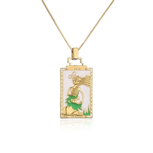 Macro view of 18K gold plated tarot La Forza pendant with detailed lion enamel artwork