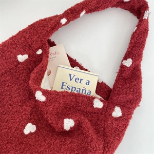 Interior detail of red teddy fleece tote bag with white hearts showing large capacity