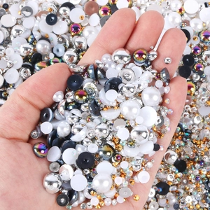 Close-up of mixed sizes resin pearls and rhinestones for DIY nail art and phone cases