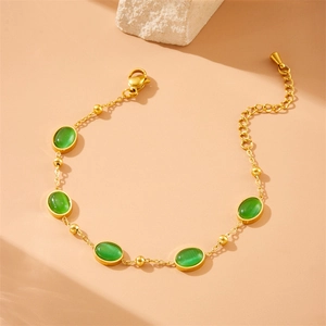 Vintage stainless steel gold bracelet with oval green cat eye stones and lobster clasp