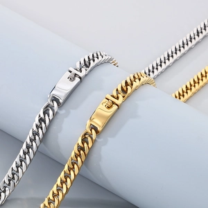 Detail of silver and gold stainless steel cuban chain bracelets with secure clasps