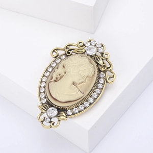 Vintage style lady relief brooch with golden frame and sparkling crystal accents
