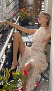 Chic cream backless halter top and tiered maxi skirt set on a sunny balcony