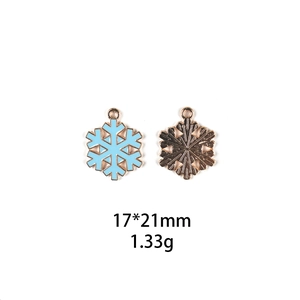 Detailed view of snowflake charms with blue enamel and 17x21mm size specifications