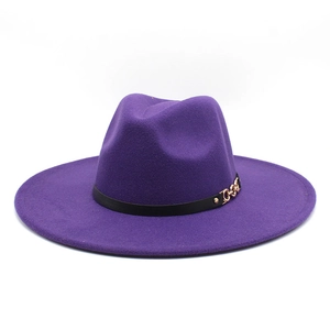 Close-up of purple wool fedora hat with elegant gold chain buckle and black leather band