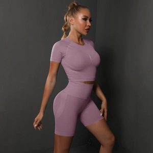 Detailed texture of seamless light purple yoga set featuring a crop top and high waist shorts