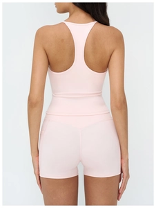 Detail of pink racerback yoga top and high-waisted shorts with functional side pockets