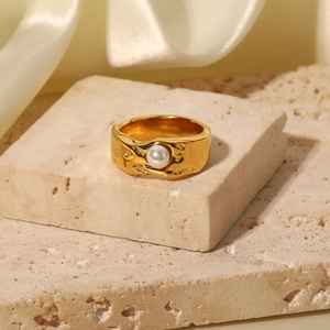 Detail of 18K gold-plated irregular lava texture ring with center white pearl inlay
