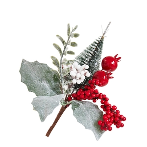Christmas decoration with red berries, frosted green leaves and mini trees on white background