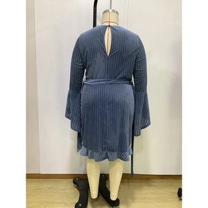 Detail of blue textured mini dress with flared sleeves, waist tie, and back cutout design