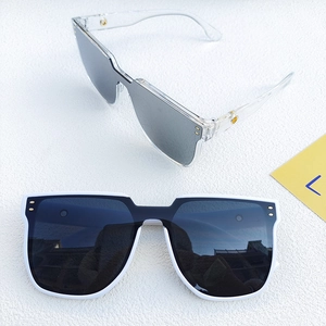 Detail of square oversized sunglasses with silver mirrored lenses and metal rivets on frames