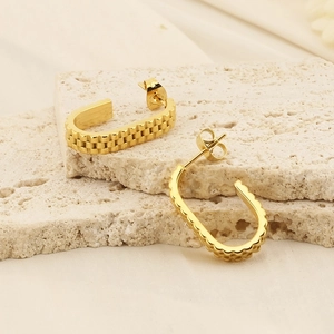 Golden U-shaped stainless steel earrings with gear texture on natural stone