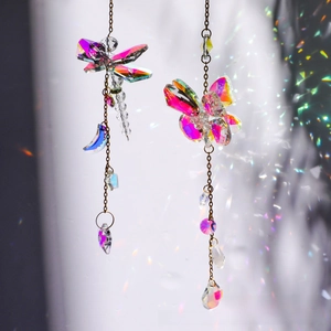 Detail of colorful crystal suncatchers with dragonfly and butterfly metal pendants