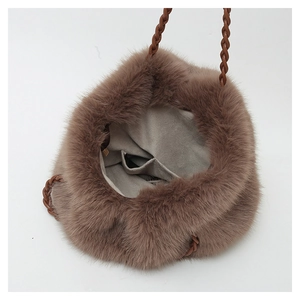 Macro view of plush tote bag interior with gray suede lining and practical divider pocket