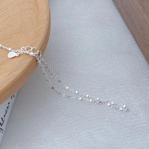 Macro shot showing S925 sterling silver hallmark and polished square link chain texture