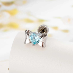 Silver bow cartilage stud earring with a blue heart zircon and sparkling crystal accents