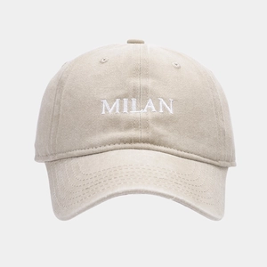 Close-up of MILAN embroidery and cotton texture on a beige washed vintage baseball cap