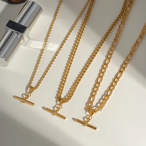 Three gold stainless steel Cuban link necklaces with horizontal bar pendants in a set
