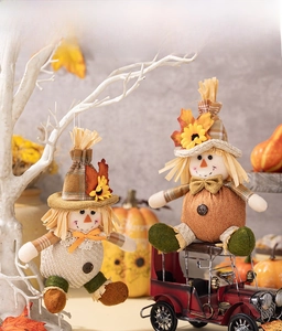 Detail showing decorative autumn scarecrow dolls with sunflowers and maple leaf accents