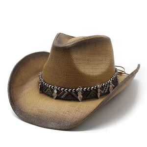 Detail of hand-painted vintage cowboy straw hat featuring an ethnic woven band and charms