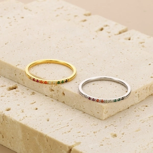 Detailed macro view of gold and silver titanium steel rings with colorful zircon stones