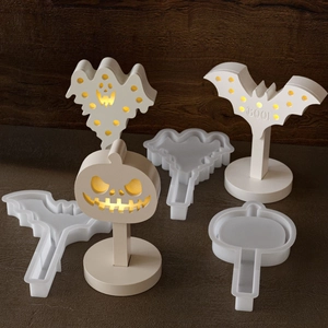 Macro detail of Halloween ghost and bat silicone molds with glowing resin finish