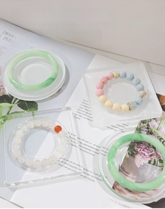 Close-up of clear acrylic jewelry display tray featuring round and square designs