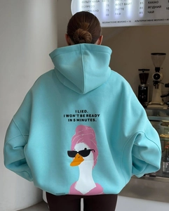 Detail of light blue oversize hoodie featuring a funny cartoon duck print on the back