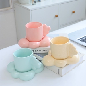 Cloud-shaped handle ceramic mug and saucer set in pastel pink, blue, and cream colors