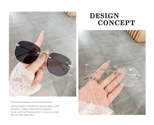 Detail view of rimless gradient sunglasses with gold metal temples and carved floral accents