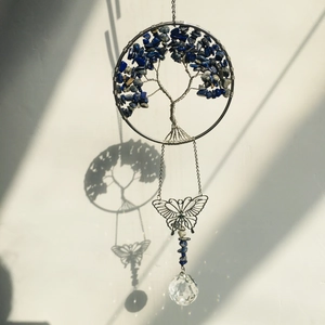 Detailed tree of life wall decor with blue stones, metal butterfly, and crystal ball prism