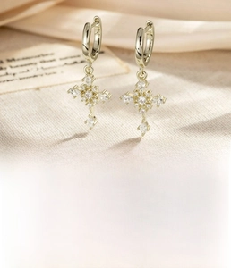 Detail of light coffee gold cross earrings with pave zircon and 8mm inner ring size