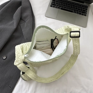 Chic light green bubble textured shoulder bag for women on white sheet background