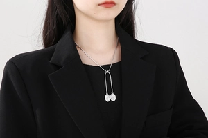 Silver Y-shaped snake chain necklace featuring double oval embossed goddess pendants