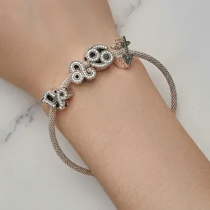 Retro S925 silver mesh bracelet with crystal numbers and star charms on model wrist