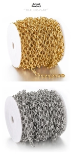 Macro view of gold and silver curved stainless steel link chain on white spools for DIY jewelry