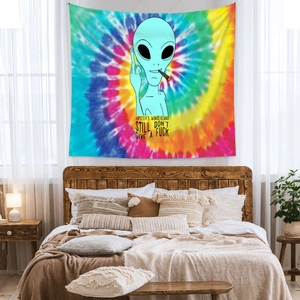 Detail of hippie alien tapestry with rainbow tie-dye pattern on a bedroom wall