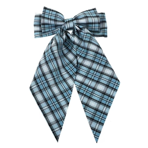 Detailed view of a blue plaid fabric bow hair clip with long elegant ribbons and metal spring