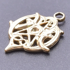 Macro view of a 18k gold plated hollow star pendant with Celtic knot metal detailing