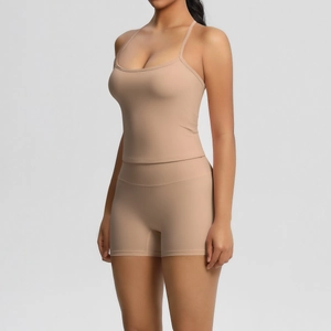Detail of nude yoga set featuring thin straps top and high-waist shorts in brushed fabric