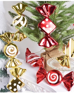 Detail of red and gold plated Christmas candy ornaments with glitter patterns
