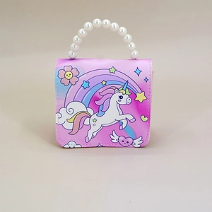Detail view of unicorn print and pearl bead handle on pink kids crossbody bag