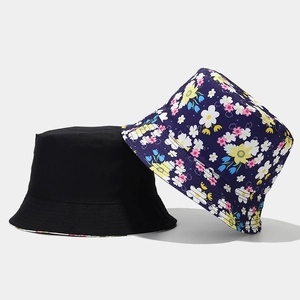 Detail showing solid black cotton bucket hat paired with a colorful floral pattern side