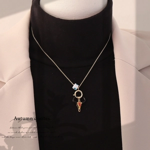 Vintage gold bull head pendant necklace with blue cube bead on a stylish winter outfit