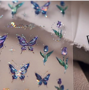 Macro shot of laser holographic butterfly nail stickers with colorful aurora glitter effects