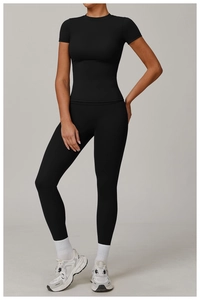 Close-up of black high-waisted yoga set with slim fit short sleeve top and leggings