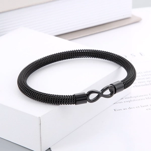 Detail of black woven mesh steel bracelet featuring a metal infinity symbol clasp
