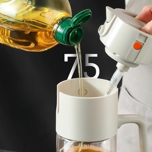 Detail of the 75mm extra-wide mouth on a glass oil sprayer for easy refilling in kitchen