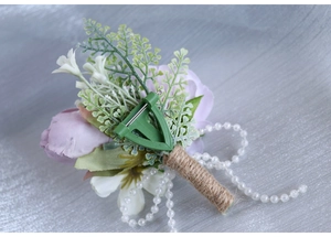 Detail of lavender rose boutonniere with jute handle and pearl chain decoration