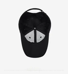 Vertical top view showing the interior structure and stitching of a black baseball cap